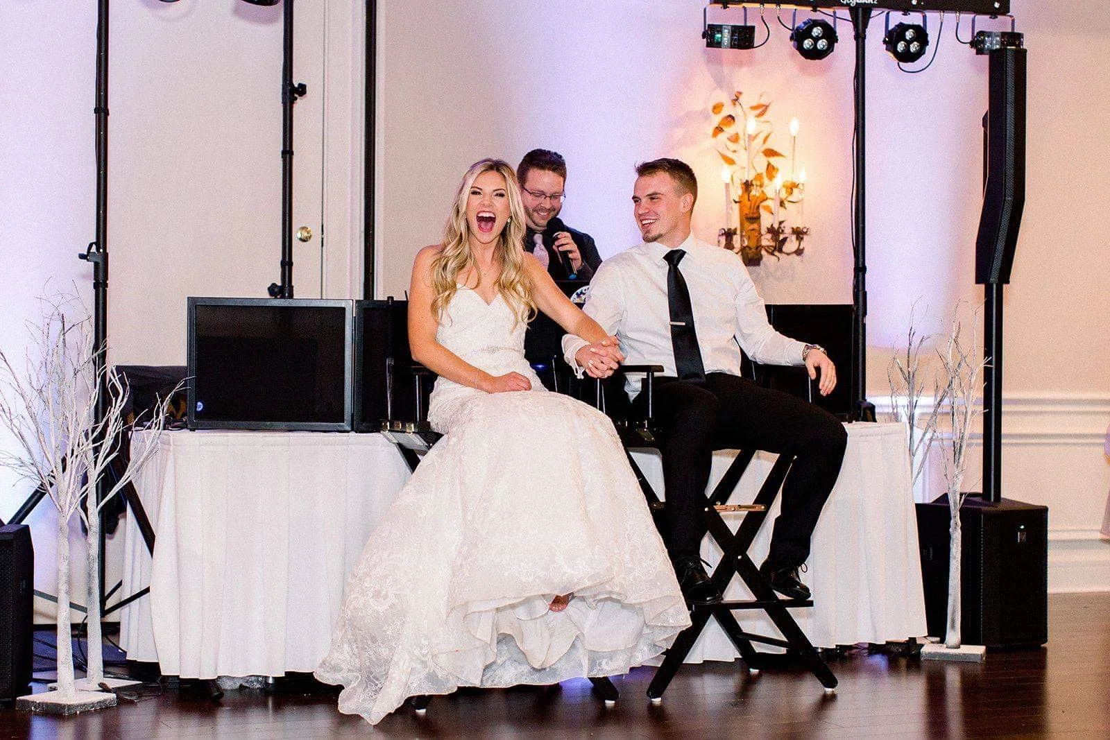 Crowded wedding dance floor with guests raising their hands